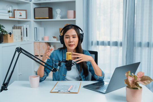 Host channel of young beautiful Asian wearing jeans creative broadcaster talking in online broadcast explaining to promote marketing or consultant in daily life with listener at studio. Stratagem.