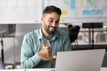 Friendly young businessman consult client by videocall using hand gestures