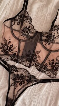 Women's set of erotic and beautiful underwear. Beige transparent bra and thong with black lace. Elegant gift