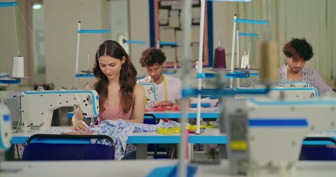 Indian young adult pupil gen z woman wear measure tape around neck sitting class room learn new casual course good sewing machine. focused teen female girl do self craft skill indoor day college place