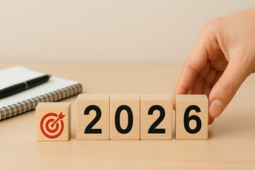 Using wooden blocks to transition from 2025 to 2026. For the next year, challenge the target business. symbolizing goals for the coming year, fresh starts, preparation, and accomplishment.