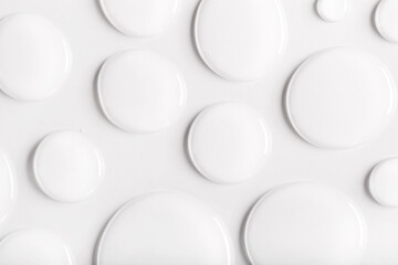 drops of transparent gel serum on gray background