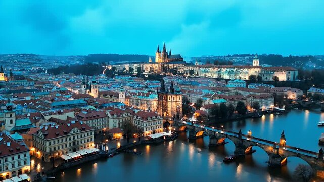 A cityscape at dusk featuring a bridge, buildings, and a cathedral, reflected in the water