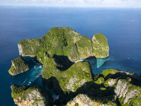 Aerial view of the rugged, verdant cliffs of Phi Phi Island rise dramatically from the turquoise waters, a tropical jewel, phi phi, krabi, Thailand.