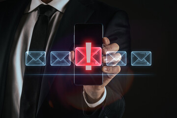 Cybersecurity concept: A businessman using a virtual interface to filter malicious spam and phishing emails