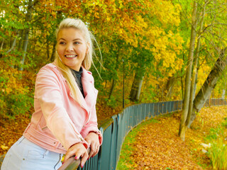 Fashion woman walking in autumn park