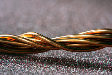Twisted copper wire close-up on glitter sparkle photography backdrop