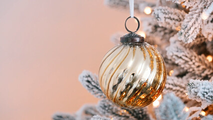 Golden bauble Christmas tree holiday decor, frosted pine needles sparkling lights, winter festive...