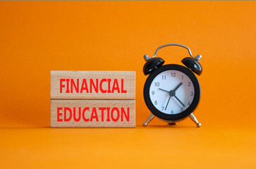 Financial Education symbol. Wooden blocks with words Financial Education. Beautiful orange...