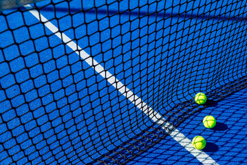 Three yellow tennis balls on a blue court viewed through the net The Art of a Minimalist Composition