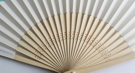 Elegant wooden hand fan with intricate design and delicate slats