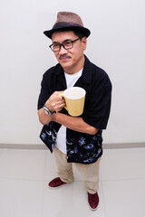 man standing alone enjoying his cup of coffee he is holding in hand