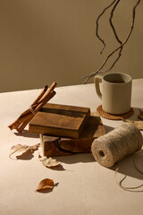 A soft setup with natural branches, logs, and cups on a beige surface, ideal for warm and organic...