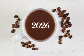 2026 written on coffee cup surrounded by roasted beans