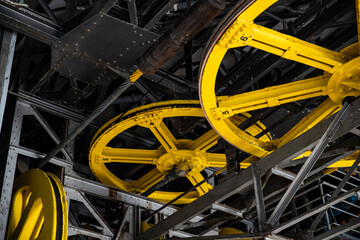 Lift technology: old metal structures and yellow drive wheels, mechanism