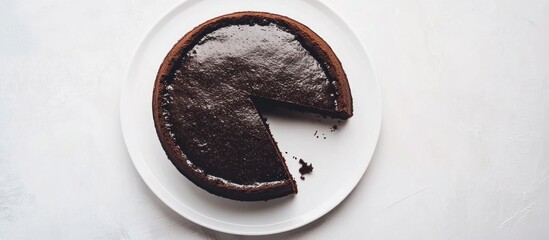 Delicious Chocolate Cake with Slice Missing on White Background overhead shot