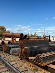Warehouse of metal products, pipes of different shapes and sizes. Vertical photo
