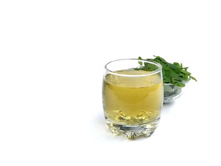 Boiled moringa leaves glass on white background. Healthy drink lifestyle, High angle view	