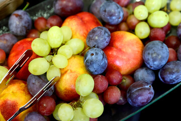 Fresh and colorfull fruits. Vibrant still life of assorted fruits photographed in natural light and stronger contrast. Selective focus.