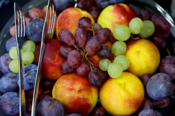 Fresh and colorfull fruits. Vibrant still life of assorted fruits photographed in natural light and stronger contrast. Selective focus.
