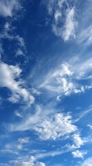 Bright blue sky with soft white clouds and sunlight, symbolizing freedom, peace, and optimism. Perfect for nature, travel, environment, wellness, and inspirational background designs with copy space.