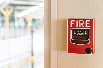 Fire alarm system notifier on wall background.Red wall-mounted fire alarm pull station in the office.Fire alarm systerm control and risk management concept.