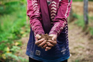 Soil restoration action by hands-on youth in nature outdoor environment close-up viewpoint environmental sustainability