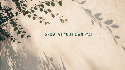 Inspirational quote Grow at your own pace on textured wall with plant leaves and shadows