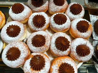 Sufganiyah - Hanukkah doughnuts on display at a coffee shop. Sufganiyot. Israeli holiday doughnuts.