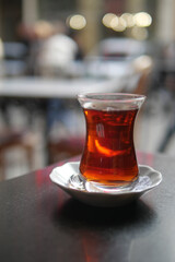 Warm turkish tea served on a small plate in a cafe setting