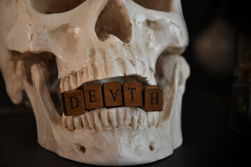 Fototapeta premium Closeup of word ''death'' in the teeth of a human skull