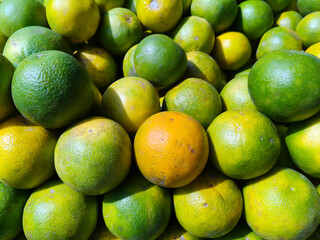 Close up shot of pile of fresh sweet lemon.