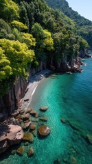 High Angle View Of A Lush Green Forested Mountain Descending To A Rocky Shoreline With Crystal Clear Turquoise Water And Sunlit Waves Below