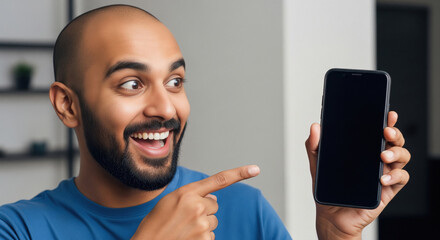 A man in a blue t-shirt points at a blank smartphone screen, emphasizing modern digital connectivity and technology usage.