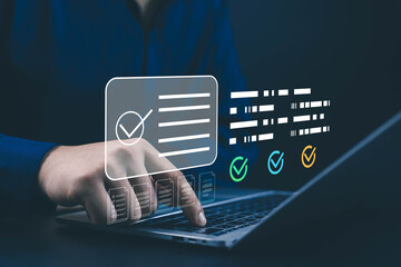 Businessman using laptop with digital checklist and task completion icons on virtual screen, symbolizing project management, workflow efficiency, productivity, and modern technology.