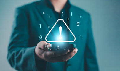 Digital cybersecurity alert concept showing businessman holding smartphone with warning symbol and binary code, representing data breach, hacking threat, malware attack, and online protection.