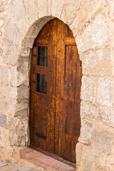 wooden doors in the stone wall of the castle