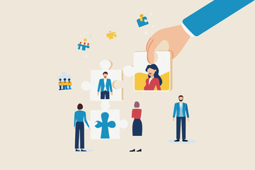 Hand placing a female employee puzzle piece into a team building concept with diverse people