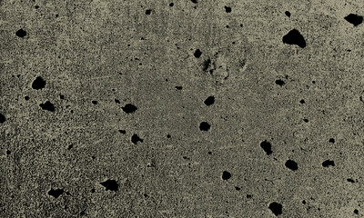 Close up texture of speckled grey concrete with dark inclusions