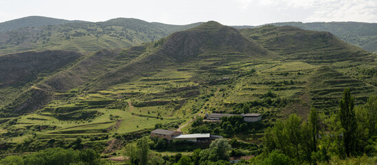 Panoramic view of a farm in the green hills in Rioja (Spain)
