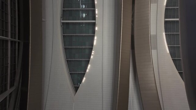 The futuristic pedestrian skylink tunnels inside Zayed International Airport, glowing with sleek lighting and ultra‑modern architectural design.
