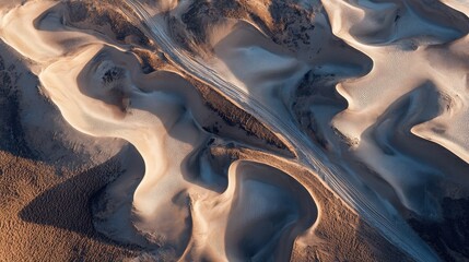 Aerial view of majestic desert dunes at sunrise with long shadows