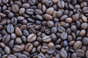 Close-up of roasted Arabica coffee beans. Background of brown roasted coffee beans
