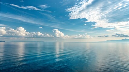 Fototapeta premium Vast ocean horizon under a dramatic blue sky with wispy clouds