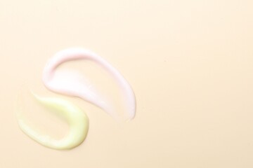 Samples of different cosmetic products on beige background, flat lay. Space for text