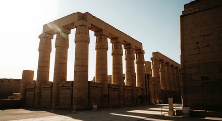 Obraz premium Ancient Egyptian Temple Columns Bathed in Sunlight.