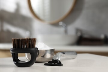 Barber's tools on white wooden table indoors, closeup. Space for text