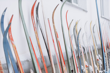 Vintage skis leaning against a white wall