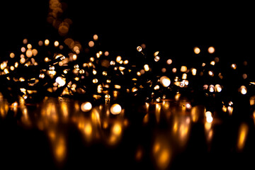 Abstract bokeh lights on a dark background. Christmas magical light, overlay or lens flare effect