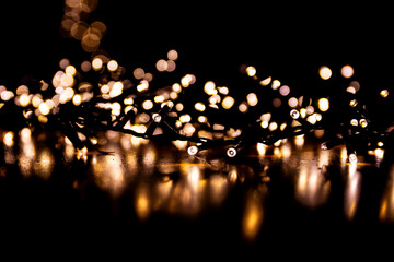 Abstract bokeh lights on a dark background. Christmas magical light, overlay or lens flare effect